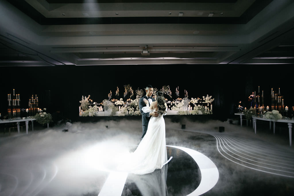 Cindy and Pankey dancing inside their monochrome JW Marriott Parq Vancouver wedding reception